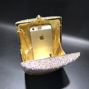 Detail showing the internal capacity of the crystal clutch bag fitting a large smartphone