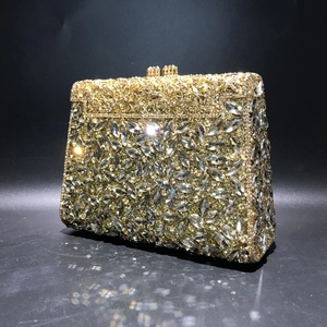 Macro detail of luxury evening clutch featuring marquise-cut rhinestones and gold metalwork