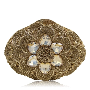Detailed view of the gold rhinestone evening clutch bag with heart-shaped crystal flower