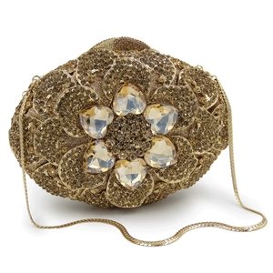 Close-up of golden evening clutch featuring sparkling rhinestones and heart crystals