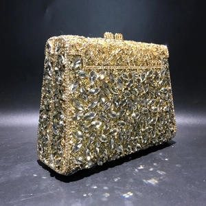 Macro shot of marquise-cut crystals and gold hollowed-out metal on luxury evening bag