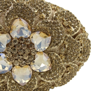 Macro view of gold metal evening clutch bag with brown floral rhinestone patterns