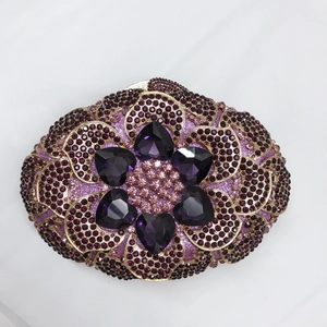Close-up of heart-shaped purple crystals and rhinestones on luxury evening clutch
