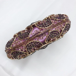 Detailed macro of the rhinestone encrusted gold hollow out evening clutch bag