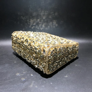 Macro detail of rectangle hard shell clutch bag with dense hand-set sparkling rhinestones