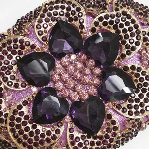 Close-up of heart-shaped purple crystals and rhinestones on luxury evening clutch