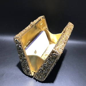 Golden evening clutch with rhinestones showing internal capacity for a smartphone