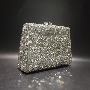 Detail of luxury evening clutch bag featuring silver rhinestones and metal clasp