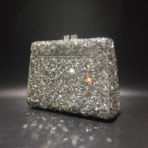 Close-up of sparkling silver evening clutch with micro-pave teardrop and round rhinestones