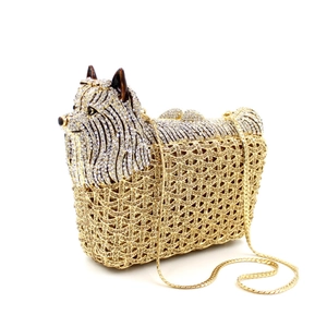 Macro shot of Yorkshire Terrier crystal clutch with silver rhinestones and gold hollow metal