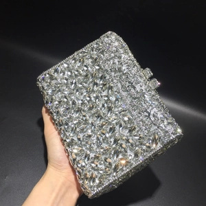 Detailed close-up of sparkling silver rhinestones on luxury evening clutch handbag