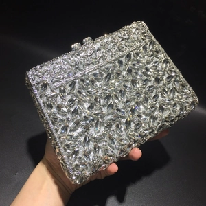 Detailed view of silver luxury evening clutch with sparkling rhinestones and metal hollow craft