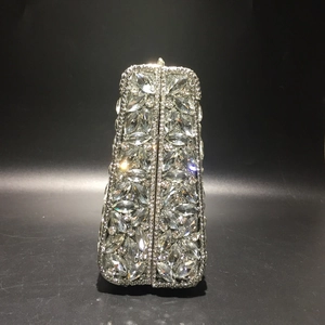 Detailed view of luxury silver clutch featuring marquise and round cut crystals on metal frame