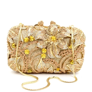 Detailed close-up of champagne crystal floral pattern on a gold metallic evening clutch