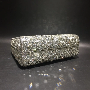 Macro shot of silver evening clutch bag featuring intricate marquise cut crystals