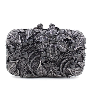 Detail of black rhinestone evening clutch with 3D crystal floral pattern on hard case