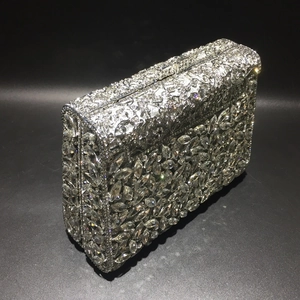 Detailed view of silver evening clutch with intricate rhinestone floral patterns