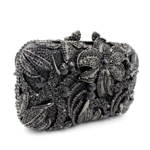 Detail of luxury black crystal evening clutch bag with 3D floral pattern design