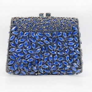 Macro detail of navy blue marquise stones and silver hollow metal floral evening clutch