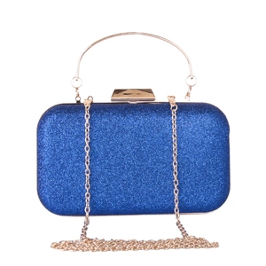 Detail of blue sequined evening clutch bag with round gold handle and metal frame