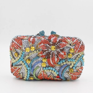 Detailed view of colorful rhinestone floral pattern on a rectangular metal evening clutch