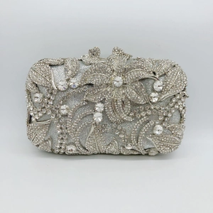 Close-up of luxury silver evening clutch with sparkling floral crystal and rhinestone pattern