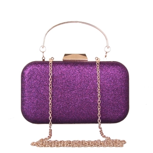 Close-up of a purple sequin evening bag with rose gold metal ring handle and chain