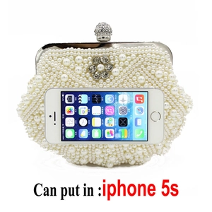 Macro view of beige pearl clutch bag interior capacity compared with a mobile phone