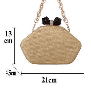 Golden shimmering evening bag with crystal bow clasp and 21cm x 13cm size specifications
