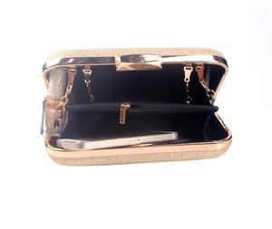 Interior detail of champagne gold clutch bag with chain strap and phone storage