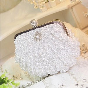 Elegant beige pearl evening bag with silver metal frame and rhinestone floral detail