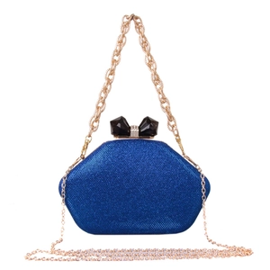 Detail of royal blue sequined evening bag with gemstone bow clasp and gold chain strap