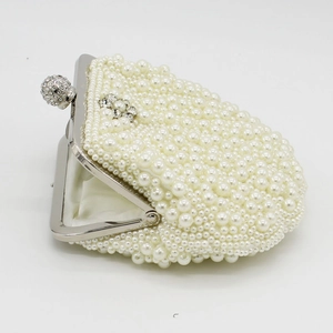 Detail of pearl evening clutch with rhinestone floral accents and silver metal frame
