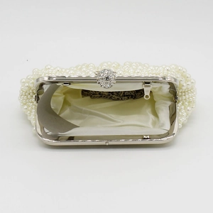 Detailed interior of pearl evening bag with silver metal chain and clasp