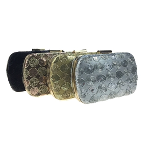 Detail of four sequined clutch bags in black, bronze, gold and silver finishes