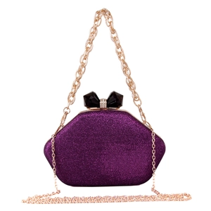 Detailed view of purple glitter evening clutch with crystal bow clasp and gold chain