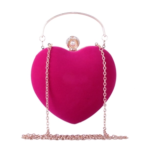 Détail du sac de soirée en velours en forme de cœur avec fermoir perle et chaîne dorée