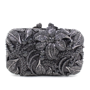 Elegant hollow metal floral evening clutch bag with black and grey crystals on white background