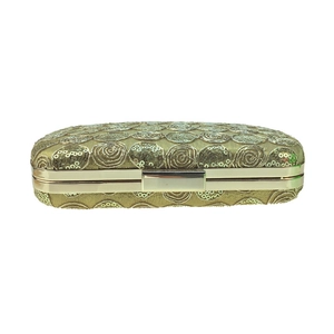 Detail of gold sequin rose embroidery on luxury hard shell evening clutch bag