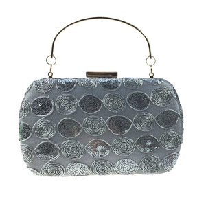 Elegant silver sequin evening clutch with circular patterns and gold metal top handle