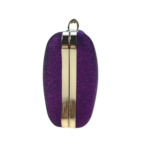 Detail view of purple sequin evening bag with gold metal frame and oval hard shell clutch
