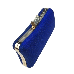 Detailed view of the royal blue evening clutch with shimmering glitter and rhinestone clasp