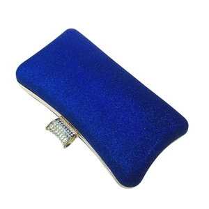Close-up of royal blue glitter clutch bag with sparkling rhinestone encrusted top clasp