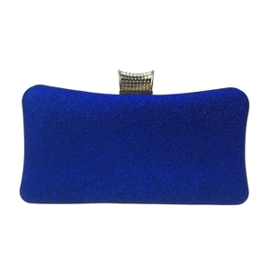 Detailed macro of royal blue sequin glitter clutch bag with golden metallic embossed clasp