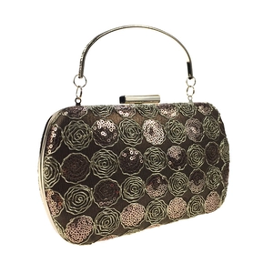 Close-up of golden floral sequin embroidery and metallic handle on evening clutch bag