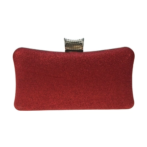 Macro shot of sparkling red glitter evening clutch bag with elegant diamond-encrusted clasp