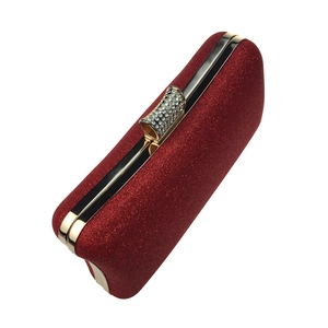 Detailed view of red sequin evening clutch bag with crystal-encrusted metal clasp