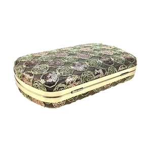 Close-up of champagne gold sequin embroidery and rose texture on the rectangular evening clutch
