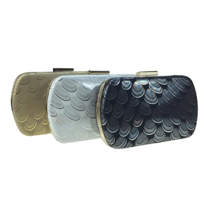 Detailed set of evening clutch bags featuring textured peacock pattern and metallic finish