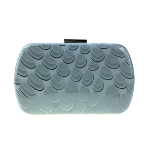 Close-up of evening clutch bag with scale pattern texture and gold metal clasp